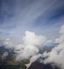 Top view of clouds above lowland of the great river