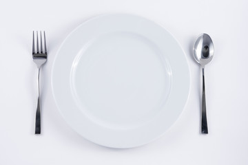 White plate , spoon and fork