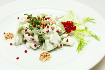 Healthy eating, salad with cucumbers, berries and nuts