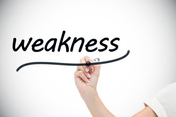 Businesswoman writing the word weaknesses