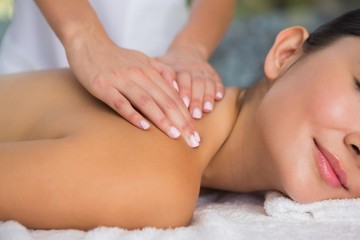 Obraz na płótnie Canvas Content brunette getting a back massage