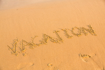 Word vacation on the yellow sandy beach