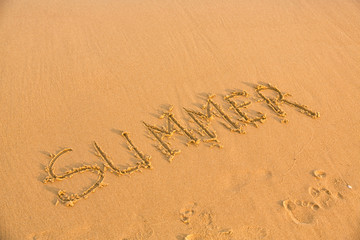 Word summer on the yellow sandy beach