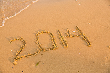 2014 numbers on the yellow sandy beach