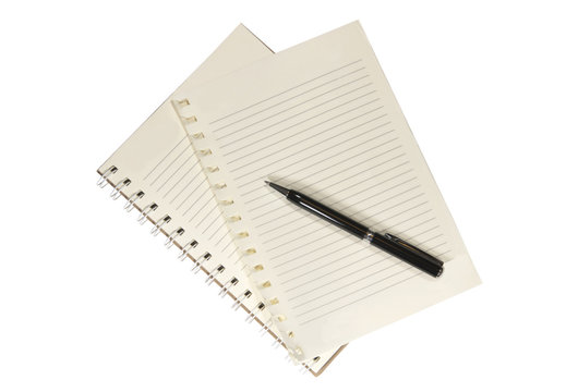 A blank white notebook and pen on the wooden table