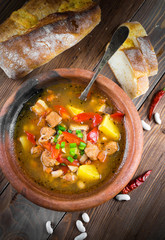 .Hungarian goulash with beans and peppers on wooden board
