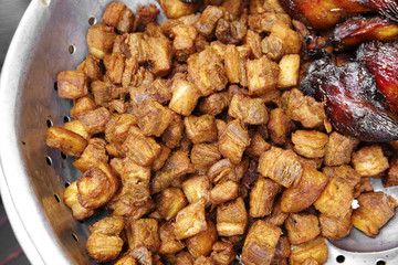 close up pork fried in wooden tray