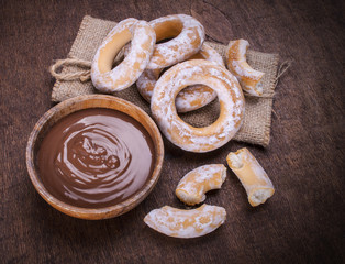 chocolate cream and bagels on dark wood background