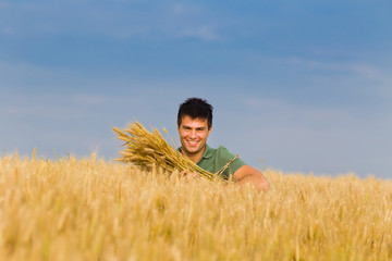Naklejka na ściany i meble Happy man in wheat field