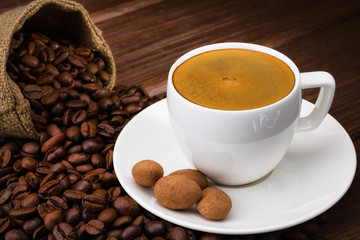 Coffee cup on a wooden table. Dark background.