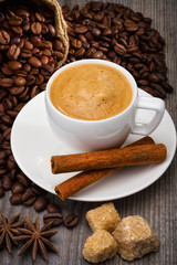 Coffee cup with coffee beans and sugar