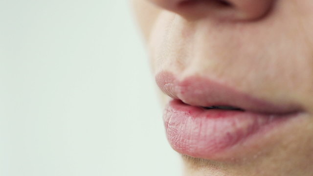 Woman talking, closeup on mouth, super slow motion