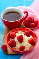 Fresh raspberries on the curd and tea