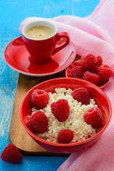 Fresh raspberries on the curd and coffee