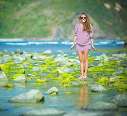 Woman Walks Alone on a Green Reef