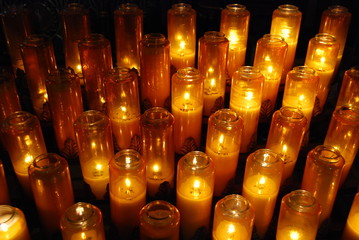 Church votive prayer candles in jars