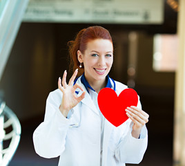 Doctor holding heart giving ok sign