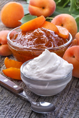 domestic apricot jam with sour cream on old rustic table