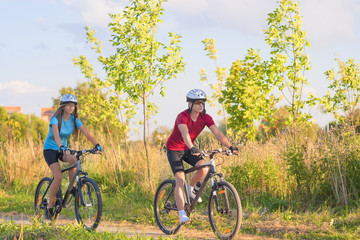 Two Cycling Athletes In Professional Gear Training Oitdoor Toget