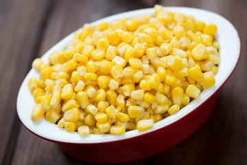 Glass bowl with sweet corn kernels, horizontal shot