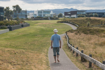 young man walking barefoot on walkway