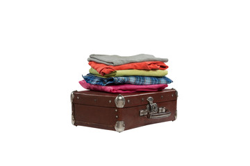stack of clothes on suitcase isolated on white background