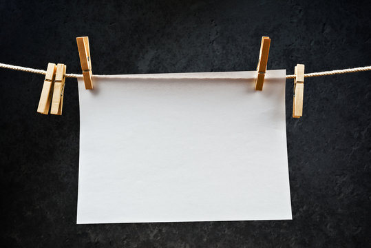 Blank note paper hanging on rope with clothes pins