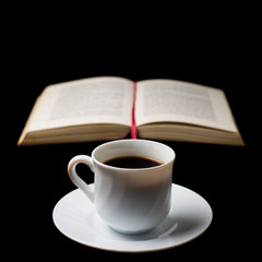 Coffee cup with old book