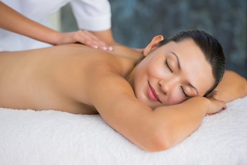 Fototapeta na wymiar Smiling brunette enjoying a back massage