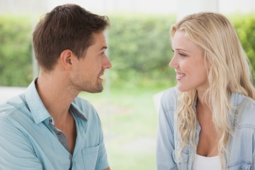 Cute young couple smiling at each other