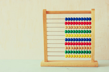 Beaded Abacus over wooden textured background  