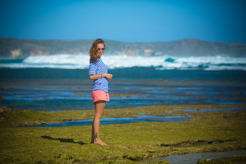 Woman Walks Alone on a Deserted Beach