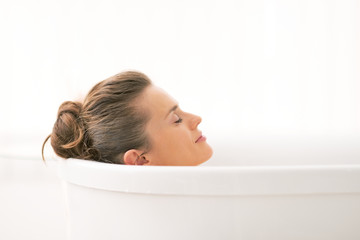Young woman relaxing in bathtub