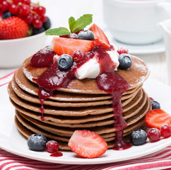 pancakes with cream, fruit sauce and fresh berries