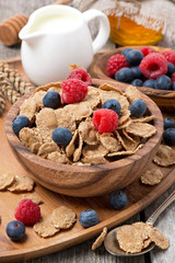 wholegrain flakes with berries, honey and milk for breakfast