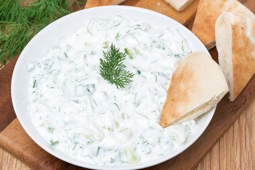 yoghurt sauce tzatziki with herbs, cucumber and garlic, top view