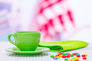 Tea cup and candy.dragees on the table