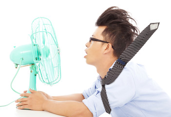 Summer heat, business man use fans to cool down