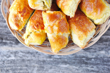 Freshly baked pies with a poppy-seed on old wooden table