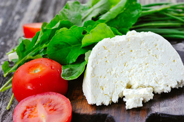 Cheese with tomatoes and arugula and onion
