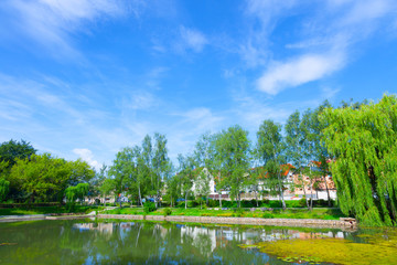Lake in the city and houses on the horizon