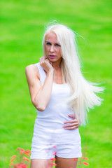 Fototapeta na wymiar Pretty Blonde Woman relaxing outdoor