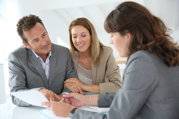 Couple meeting financial adviser for loan granting