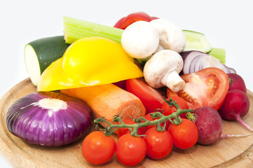 fresh vegetables and mushrooms on a wooden table