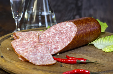 sausages on a wooden plate with vegetables in a restaurant