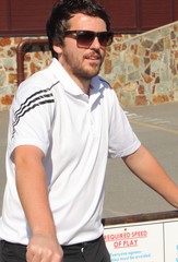 A young white male wearing a white shirt and sunglasses