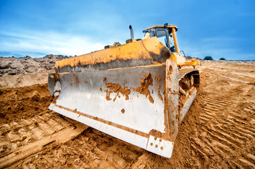 close-up of bulldozer blade, industrial machines working in sand