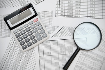calculator and magnifier on documents.