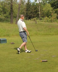 A golfer after hitting the golfball down the fairway