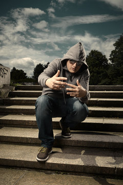 Hood man on stairs in park
